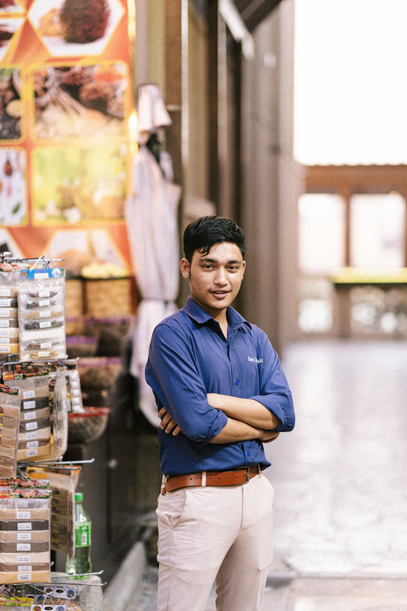 A young man standing confidently inside a retail store