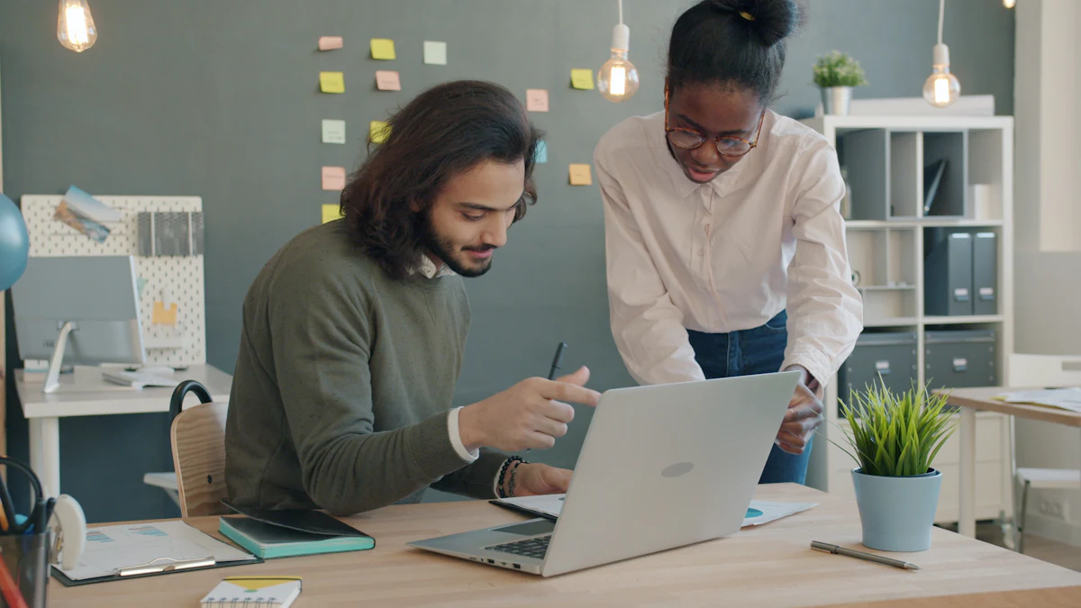 Two colleagues working together at a laptop